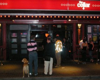 Charles talking to the bouncer at the Cellar, the club below their hotel