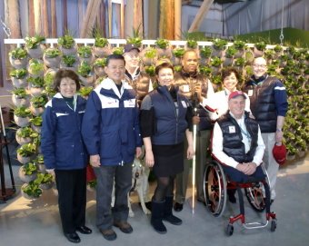 the delegation group in front of the living wall