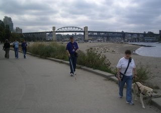 Group walking along the boardwalk to Stanley Park