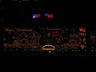 Buildings decorated in the Christmas theme, a night-time harbor view