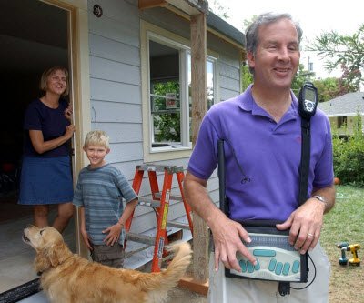 Mike in front of his house with navigational technology
