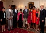 From left to right: Valerie Jarrett, Senior Advisor and Assistant to the President, Kareem Dale, Assistant to the President for Disability Affairs, President Obama, Bonnie St. John, amputee skier from 1984 Paralympics, Mike May, blind skier from 1984 Paralympics and 1982 Winter games , Peggy Flemming, gold medal ice-skater from 1968 Olympics, Michelle Obama , Dr. Jill Biden , Vice-President Joe Biden, Mike's Seeing Eye dog, Miguel, is poking out at knee level between Mike and Peggy