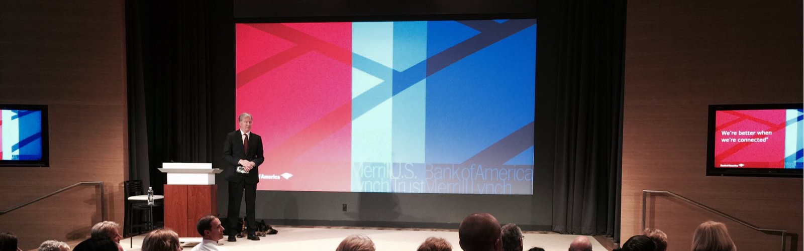 Mike speaking at Bank of America with his Seeing Eye dog at his feet
